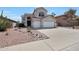 Two story home featuring a neutral color scheme, red roof, landscaping, and a spacious three car garage at 5959 W Lone Cactus Dr, Glendale, AZ 85308