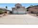 Two story home featuring a neutral color scheme, red roof, landscaping, and a spacious three car garage at 5959 W Lone Cactus Dr, Glendale, AZ 85308