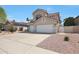 Two story home featuring a neutral color scheme, red roof, landscaping, and a spacious three car garage at 5959 W Lone Cactus Dr, Glendale, AZ 85308