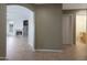 Hallway view showcasing the transition between the living area, bathroom, and other rooms with tiled floors and neutral walls at 5959 W Lone Cactus Dr, Glendale, AZ 85308