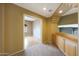 Second-floor hallway with built-in wooden cabinetry, beige carpet, and view into room at 5959 W Lone Cactus Dr, Glendale, AZ 85308