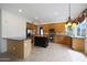 Bright kitchen featuring stainless steel appliances, tile flooring, a center island and ample countertop space at 5959 W Lone Cactus Dr, Glendale, AZ 85308
