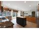 Spacious kitchen with stainless steel appliances, a center island, and a view of the backyard with a pool at 5959 W Lone Cactus Dr, Glendale, AZ 85308