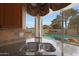 The kitchen sink boasts a great view of the swimming pool with tropical landscaping in the backyard at 5959 W Lone Cactus Dr, Glendale, AZ 85308