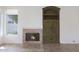 Inviting living room showcases a fireplace, built-in cabinet, and a bright window at 5959 W Lone Cactus Dr, Glendale, AZ 85308
