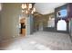 Bright, spacious living room with a tall ceiling, chandelier, and staircase at 5959 W Lone Cactus Dr, Glendale, AZ 85308