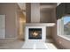Spacious living area with a fireplace, carpet, and lots of natural light at 5959 W Lone Cactus Dr, Glendale, AZ 85308