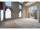 Bright, spacious living room with a tall ceiling, large windows, and a chandelier at 5959 W Lone Cactus Dr, Glendale, AZ 85308
