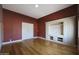 Living room with wooden floors, built-in media center, and view into hallway at 5959 W Lone Cactus Dr, Glendale, AZ 85308