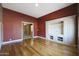 Living room with wooden floors and built-in shelves and cabinets at 5959 W Lone Cactus Dr, Glendale, AZ 85308