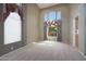 Bright, spacious living room with tall ceiling, large windows with curtains, and tile floors at 5959 W Lone Cactus Dr, Glendale, AZ 85308