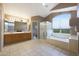 Bright bathroom with dual vanities, soaking tub, and a walk-in shower at 5959 W Lone Cactus Dr, Glendale, AZ 85308
