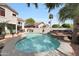 Resort-style backyard features a stunning pool, outdoor kitchen, and lush tropical landscaping at 5959 W Lone Cactus Dr, Glendale, AZ 85308
