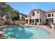 Inviting backyard oasis featuring a sparkling pool, lush landscaping, and a spacious patio with seating at 5959 W Lone Cactus Dr, Glendale, AZ 85308