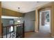 Staircase landing with wrought iron railing, decorative lighting, and neutral paint at 5959 W Lone Cactus Dr, Glendale, AZ 85308
