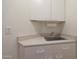 Utility sink area with white cabinets and drawers, and a convenient countertop at 5959 W Lone Cactus Dr, Glendale, AZ 85308