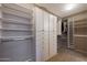 Well-organized walk-in closet featuring ample shelving and custom storage solutions at 5959 W Lone Cactus Dr, Glendale, AZ 85308