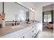 Modern bathroom featuring double sinks, sleek black fixtures, and a large mirror at 6108 E Shasta Daisy Ln, Prescott Valley, AZ 86315