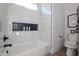 Bright bathroom featuring tiled shower, decorative niche, and modern toilet at 6108 E Shasta Daisy Ln, Prescott Valley, AZ 86315