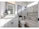 Modern bathroom featuring a vanity, tub-shower combo, and marble tiled shower wall at 6108 E Shasta Daisy Ln, Prescott Valley, AZ 86315