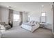 Spacious primary bedroom with neutral tones, large window, and an accent chair at 6108 E Shasta Daisy Ln, Prescott Valley, AZ 86315