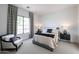 Inviting bedroom with a plush bed, stylish chair, and patterned curtains framing the window at 6108 E Shasta Daisy Ln, Prescott Valley, AZ 86315