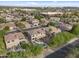 High aerial shot showcases a neighborhood with well-manicured lawns, swimming pools, and tan two-story houses at 630 S Boulder Ct, Gilbert, AZ 85296