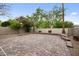 The backyard is fenced in with a hardscape patio that has beautiful flowering trees and shrubs at 630 S Boulder Ct, Gilbert, AZ 85296