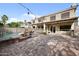 The backyard has a brick paver patio with a pool, mature landscaping and a covered patio area at 630 S Boulder Ct, Gilbert, AZ 85296
