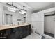 Elegant bathroom featuring dual sinks, a shower, a toilet, and decorative crystal chandeliers for a luxurious experience at 630 S Boulder Ct, Gilbert, AZ 85296