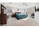 A primary bedroom featuring a ceiling fan, carpet floors, natural light, and an exercise machine at 630 S Boulder Ct, Gilbert, AZ 85296