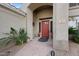 Inviting entryway with a red front door, decorative plants, and a stone walkway at 630 S Boulder Ct, Gilbert, AZ 85296