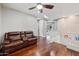 Spacious living room with hardwood floors, neutral paint and a cozy brown leather sofa at 630 S Boulder Ct, Gilbert, AZ 85296