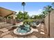Backyard view of inground pool and spa with rock waterfall feature and desert landscaping at 630 S Boulder Ct, Gilbert, AZ 85296