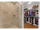 Bright bathroom showcasing a glass-enclosed shower and an organized walk-in closet at 6803 E Main St # 1106, Scottsdale, AZ 85251