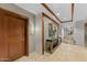 Hallway view with travertine floor, decor niche, and wood door with unit number at 6803 E Main St # 1106, Scottsdale, AZ 85251