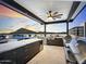 Beautiful rooftop outdoor kitchen with stainless appliances, island, BBQ, pool, and stunning sunset views at 6803 E Main St # 1106, Scottsdale, AZ 85251