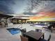 Luxurious rooftop area with a pool, lounge area, and covered bar area with a sunset view at 6803 E Main St # 1106, Scottsdale, AZ 85251