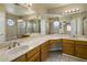 Bright bathroom with a double sink vanity, an extra-large mirror, and a shower-tub combo at 7009 W Taro Ln, Glendale, AZ 85308