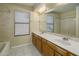 Well-lit bathroom featuring dual sinks, a large mirror, and a shower-tub combo at 7009 W Taro Ln, Glendale, AZ 85308