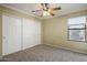 Bedroom featuring carpet, closet, natural light through window and crown molding at 7009 W Taro Ln, Glendale, AZ 85308