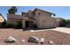Charming two-story home with a red rock yard and arched entrance at 7009 W Taro Ln, Glendale, AZ 85308