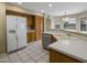 Kitchen featuring white appliances, wooden cabinets, and bright white countertops at 7009 W Taro Ln, Glendale, AZ 85308
