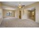 Open living area with carpet, bar area, large window, and neutral paint at 7009 W Taro Ln, Glendale, AZ 85308