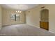 Spacious living room with vaulted ceilings, a bar area, and neutral paint at 7009 W Taro Ln, Glendale, AZ 85308