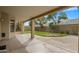 Covered patio overlooking the grassy backyard featuring ample space and supporting pillars at 7009 W Taro Ln, Glendale, AZ 85308