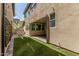 A charming backyard featuring a covered patio, BBQ area and artificial turf at 7138 W Kent Dr, Chandler, AZ 85226