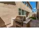 Backyard with a built-in stainless steel barbeque and manicured artificial turf at 7138 W Kent Dr, Chandler, AZ 85226