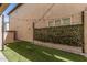 Turfed backyard with privacy landscaping and decorative string lighting overhead at 7138 W Kent Dr, Chandler, AZ 85226