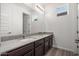 A bathroom features double sinks, granite countertops, and wood-look floors at 7138 W Kent Dr, Chandler, AZ 85226